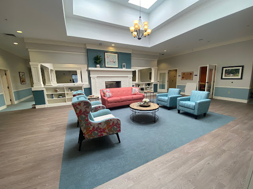 A bright and inviting living room with colorful furniture and ample natural light.