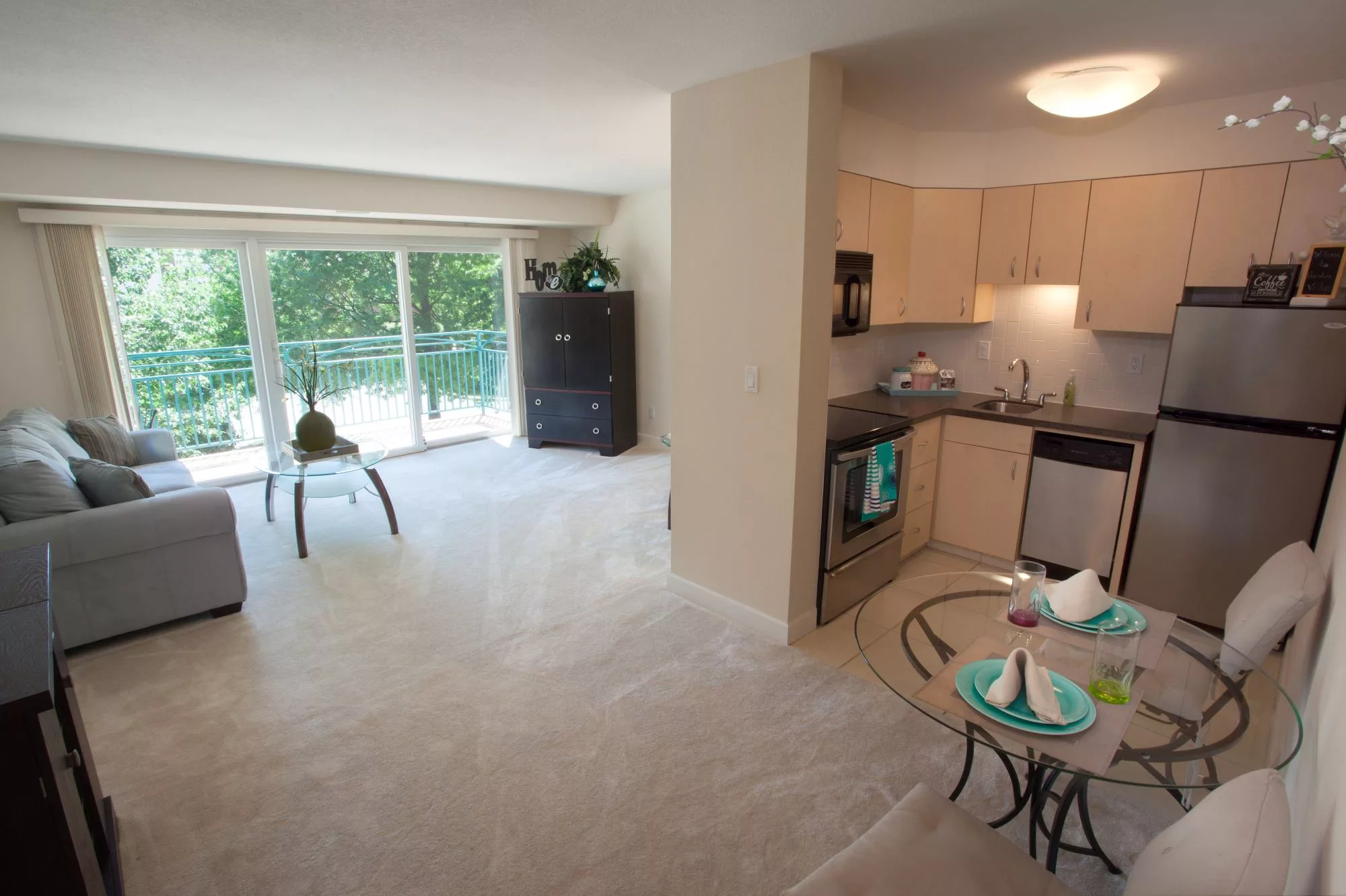 A modern open-plan apartment with a living area and compact kitchen.