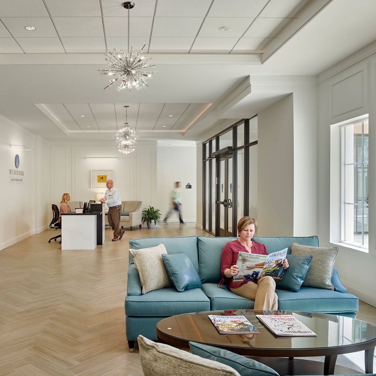 A modern office waiting area with comfortable seating and bright lighting.