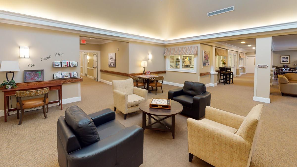 A comfortable lobby area featuring armchairs and a coffee table in a well-lit room.