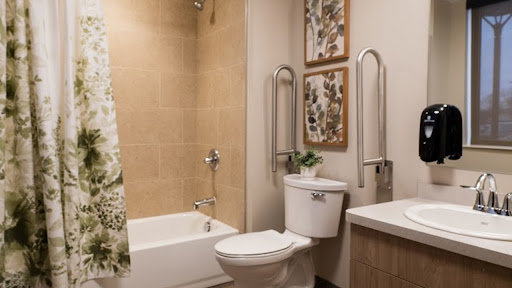 A modern bathroom featuring a bathtub, toilet, and stylish decor.