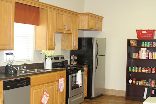 A modern kitchen featuring wooden cabinets and stainless steel appliances.