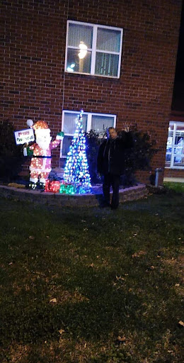 A festive display featuring Santa Claus and a brightly lit Christmas tree.