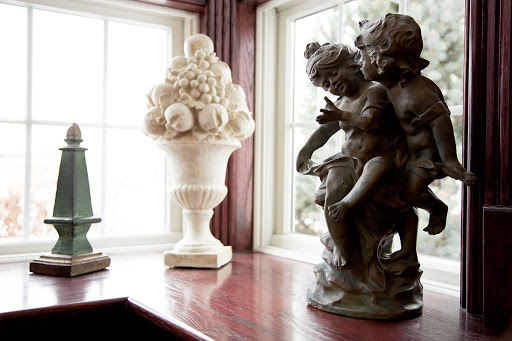 A collection of elegant sculptures placed by a window, showcasing artistic design and home decor.