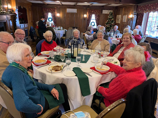 A joyful gathering of seniors enjoying a festive meal together.