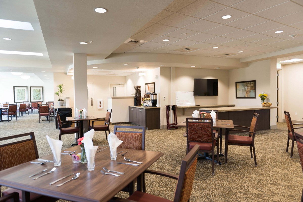 A restaurant interior with neatly set tables and chairs, ready for diners.