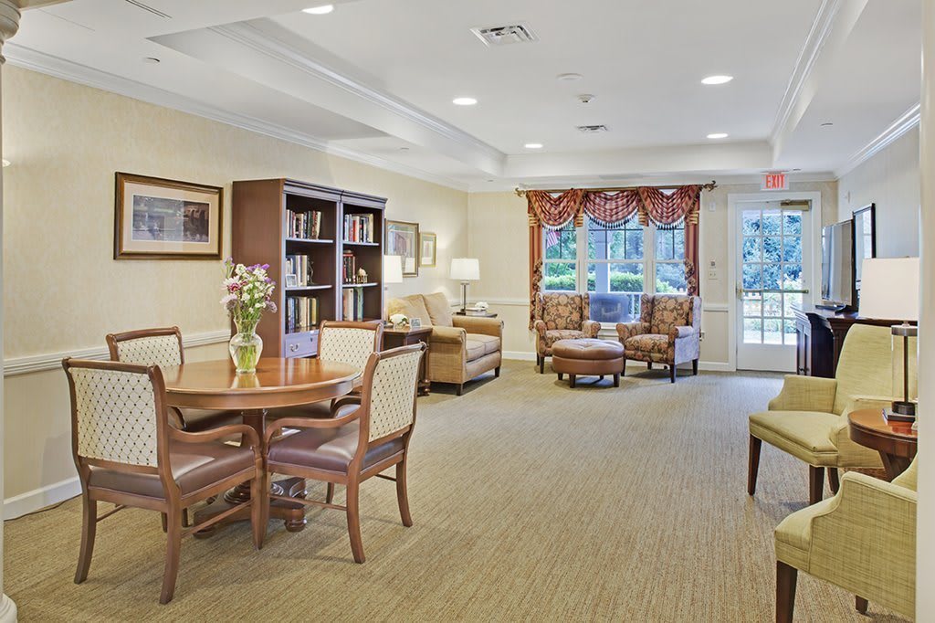 A cozy living room with comfortable seating and a bookshelf.