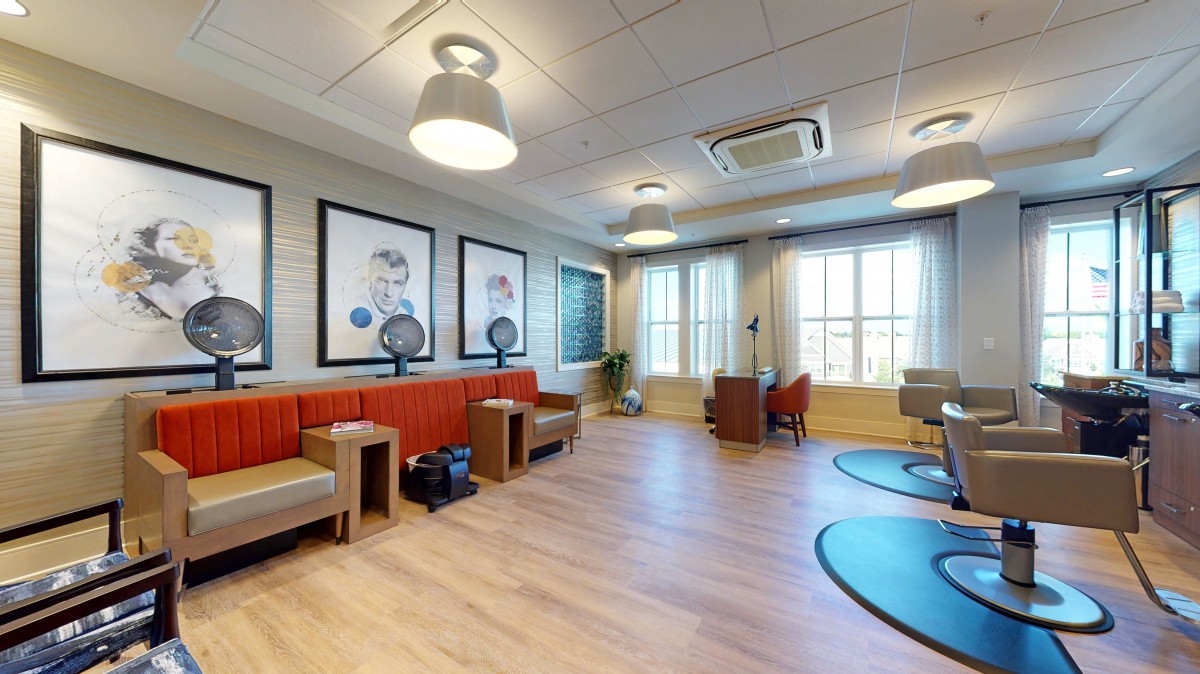 A modern waiting room with comfortable seating and stylish artwork on the walls.