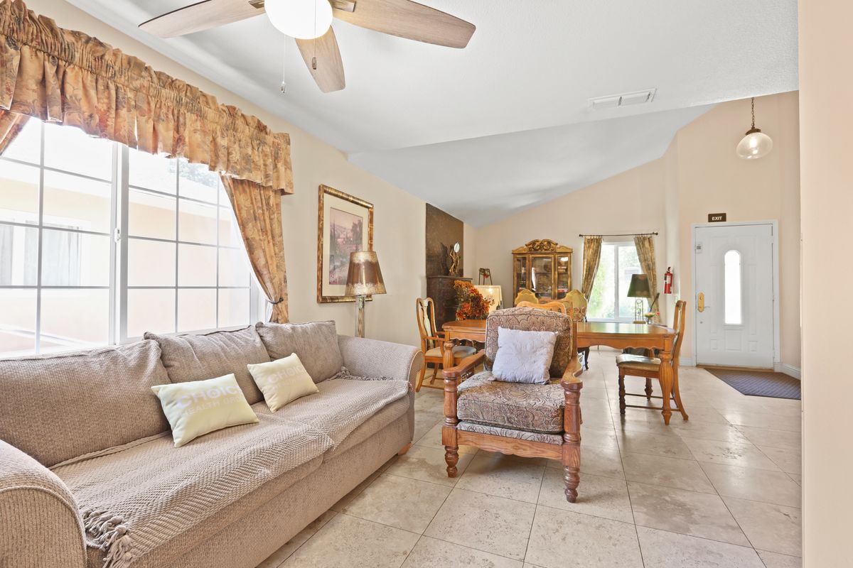 Cozy living room with a sofa, chairs, and dining area.