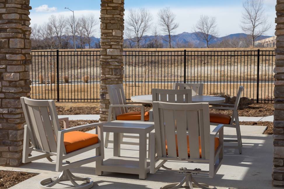 Outdoor patio with furniture overlooking a mountain view.