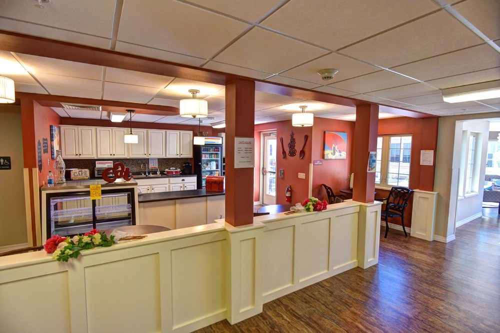 A modern and cozy kitchen and dining area with wood flooring and stylish lighting.
