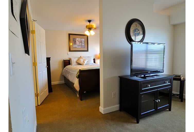 A cozy bedroom with elegant furniture and a TV.