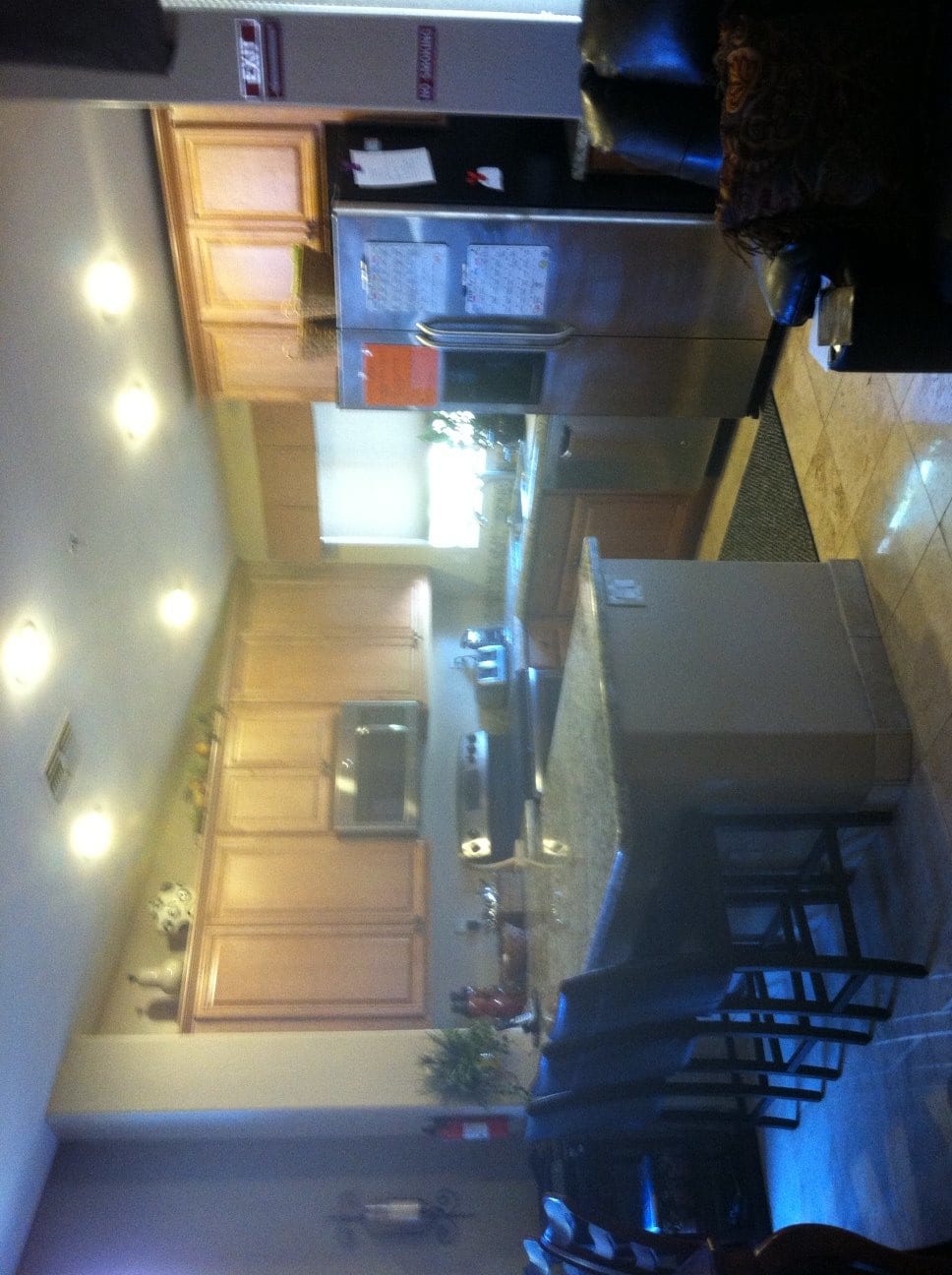 A modern kitchen featuring an island and wooden cabinets.