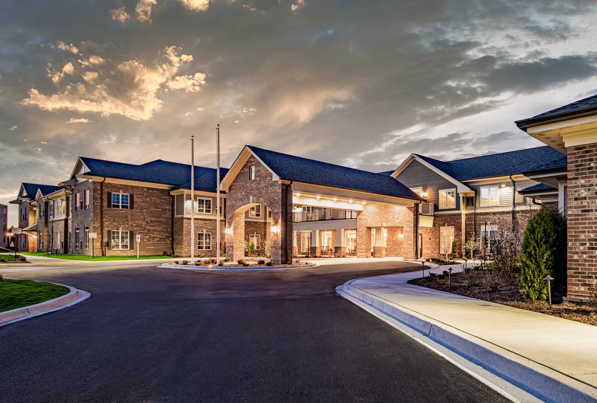 A modern building exterior illuminated at dusk.