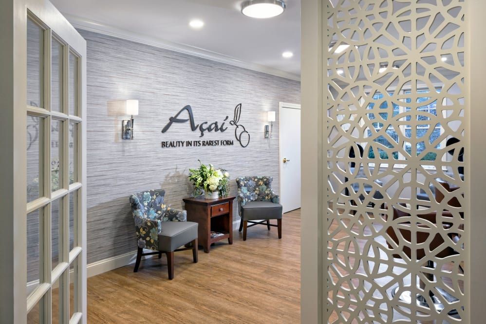 A welcoming waiting area with chairs, wall decor, and a floral arrangement.