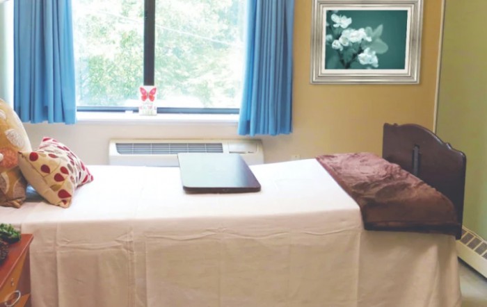 A serene massage room with a treatment bed and calming decor.