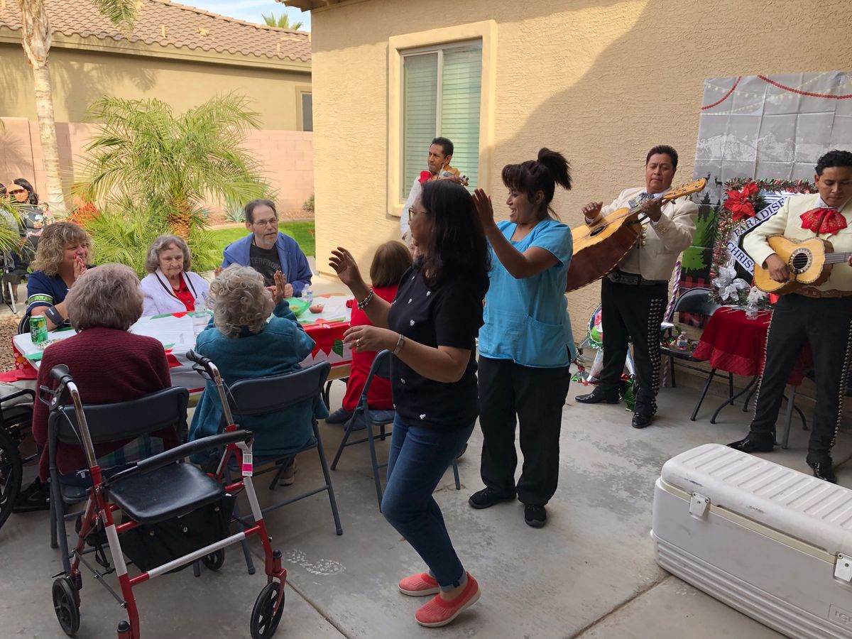 A lively outdoor gathering with people enjoying music and dancing.