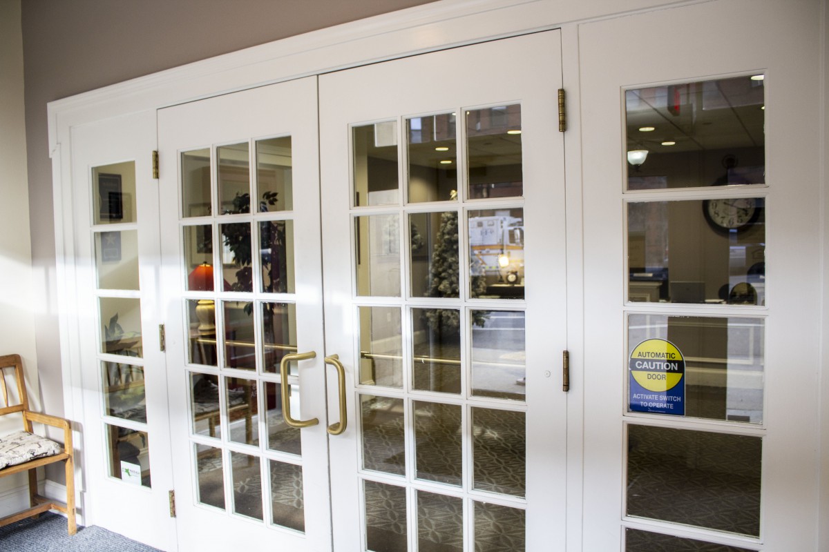 White framed glass-paneled doors leading into an office space.