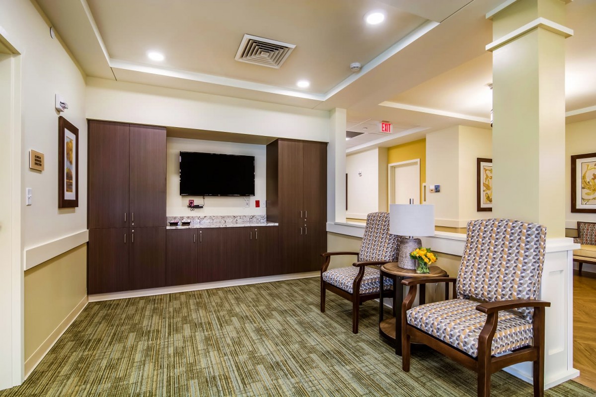 A modern lobby area with comfortable seating and a wall-mounted TV.