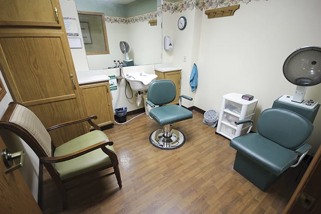 A small dentist office with a chair and medical equipment.