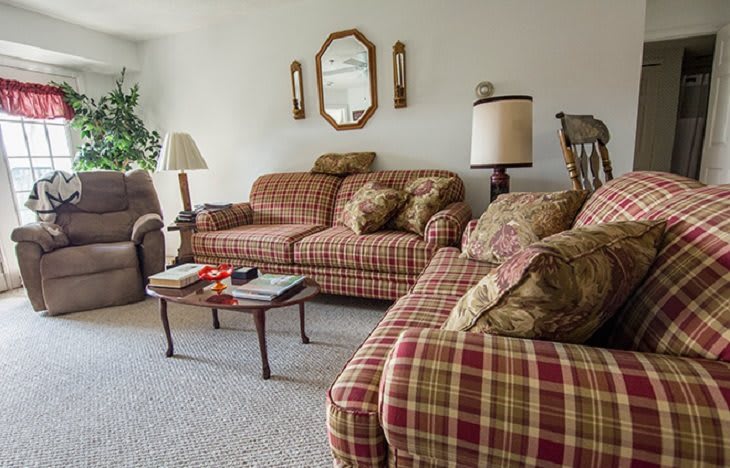 A cozy living room with plaid sofas and a coffee table.