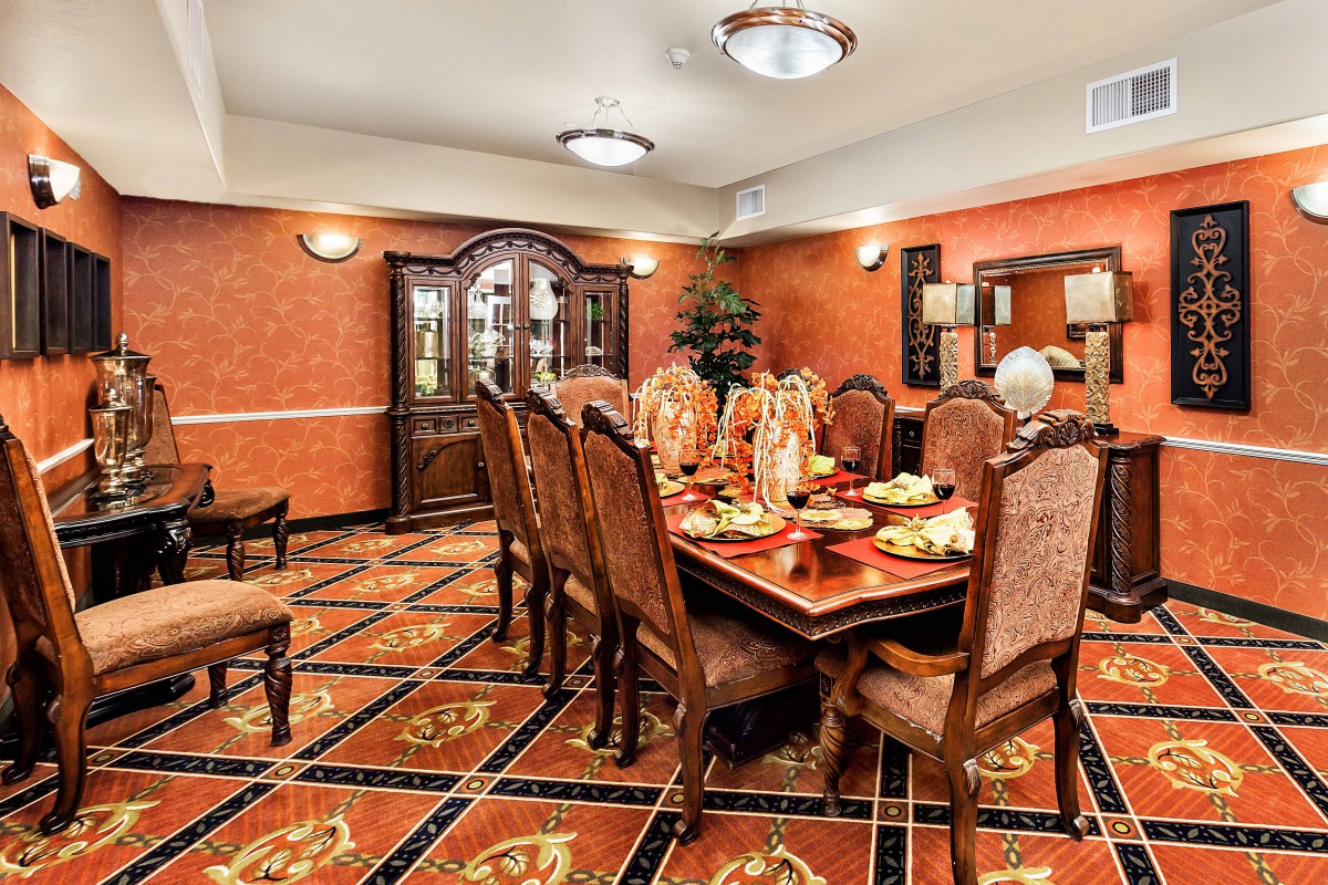 An elegantly decorated dining room with a finely set table and ornate furnishings.