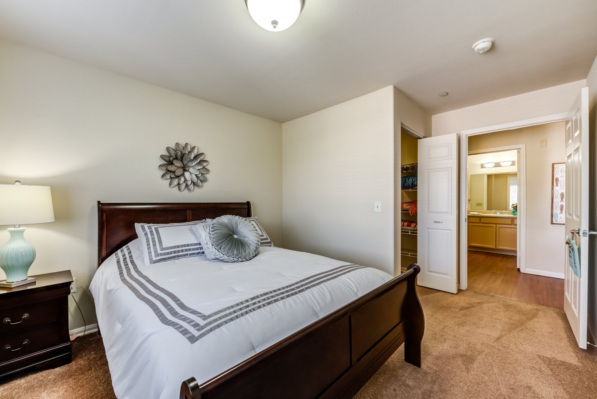 A modern and clean bedroom with a neatly made bed and minimalist decor.