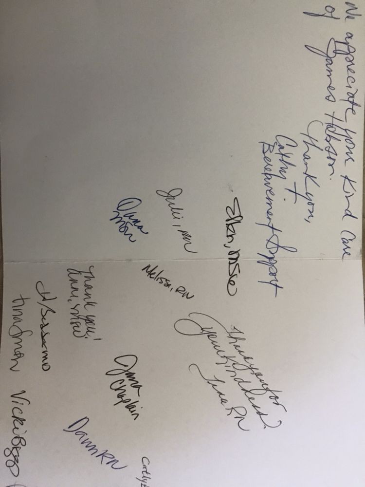 A sheet of paper filled with various handwritten signatures and personal messages.