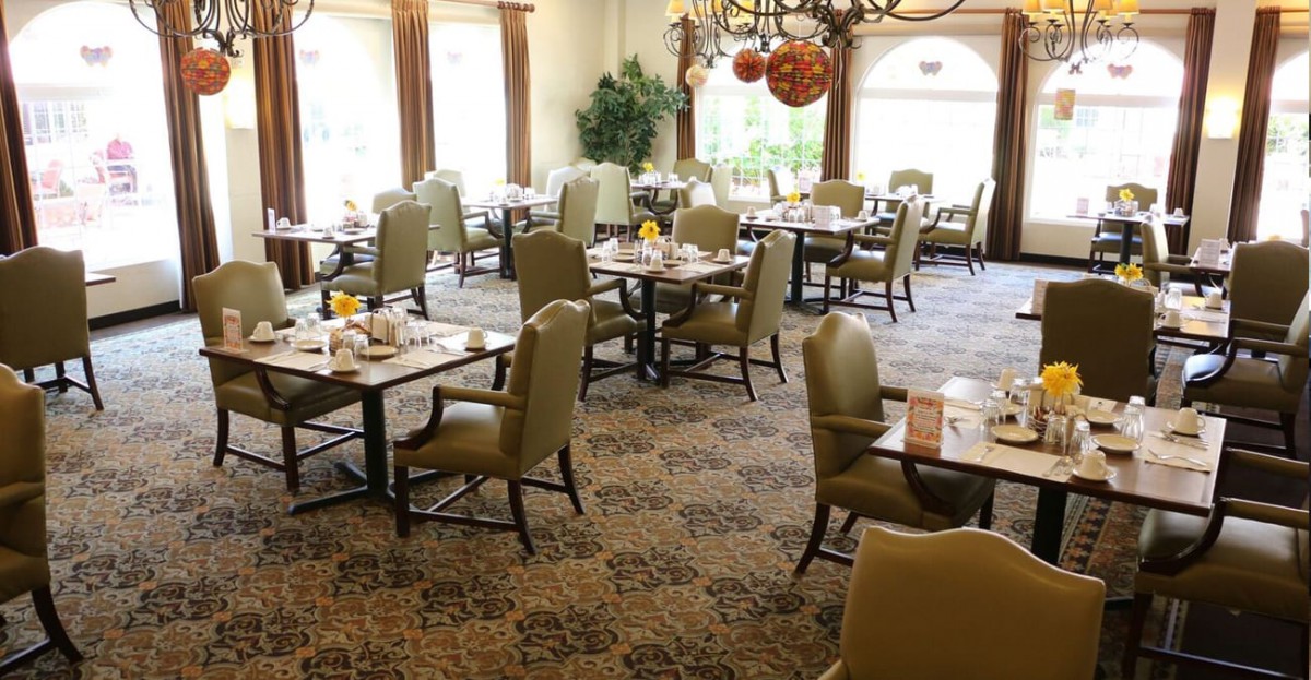 An elegant dining room with neatly arranged tables and chairs.
