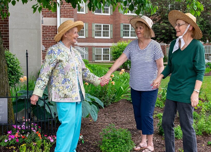 Women enjoying time together in a garden.