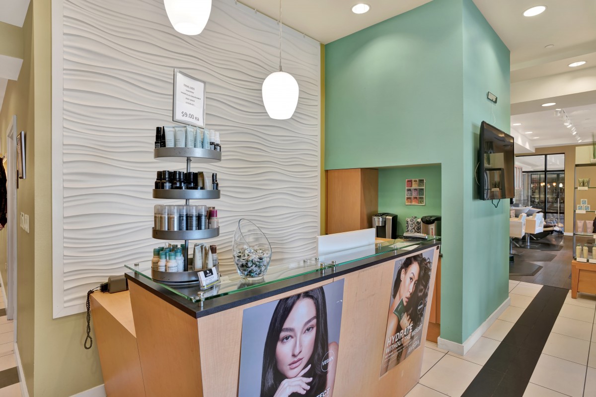 A modern salon reception area with beauty products and stylish decor.