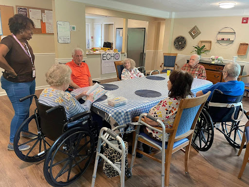 A group of seniors engaging in conversation at a community center.