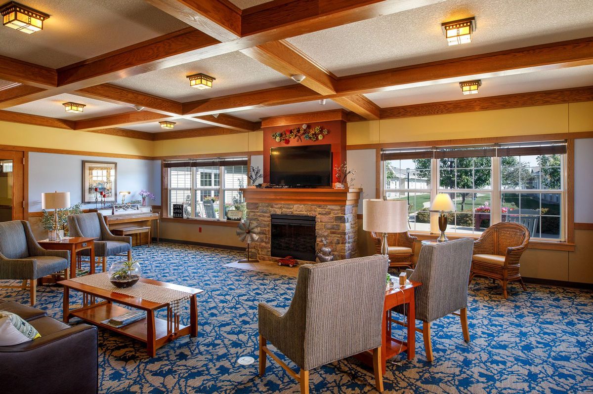 A cozy living room with a fireplace and comfortable seating.