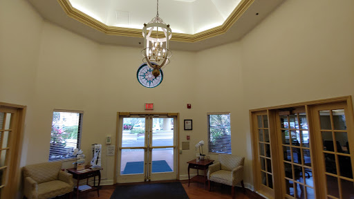 A welcoming lobby featuring a chandelier and a decorative clock.