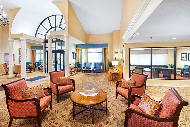 A spacious and elegantly designed hotel lobby featuring comfortable seating and warm lighting.