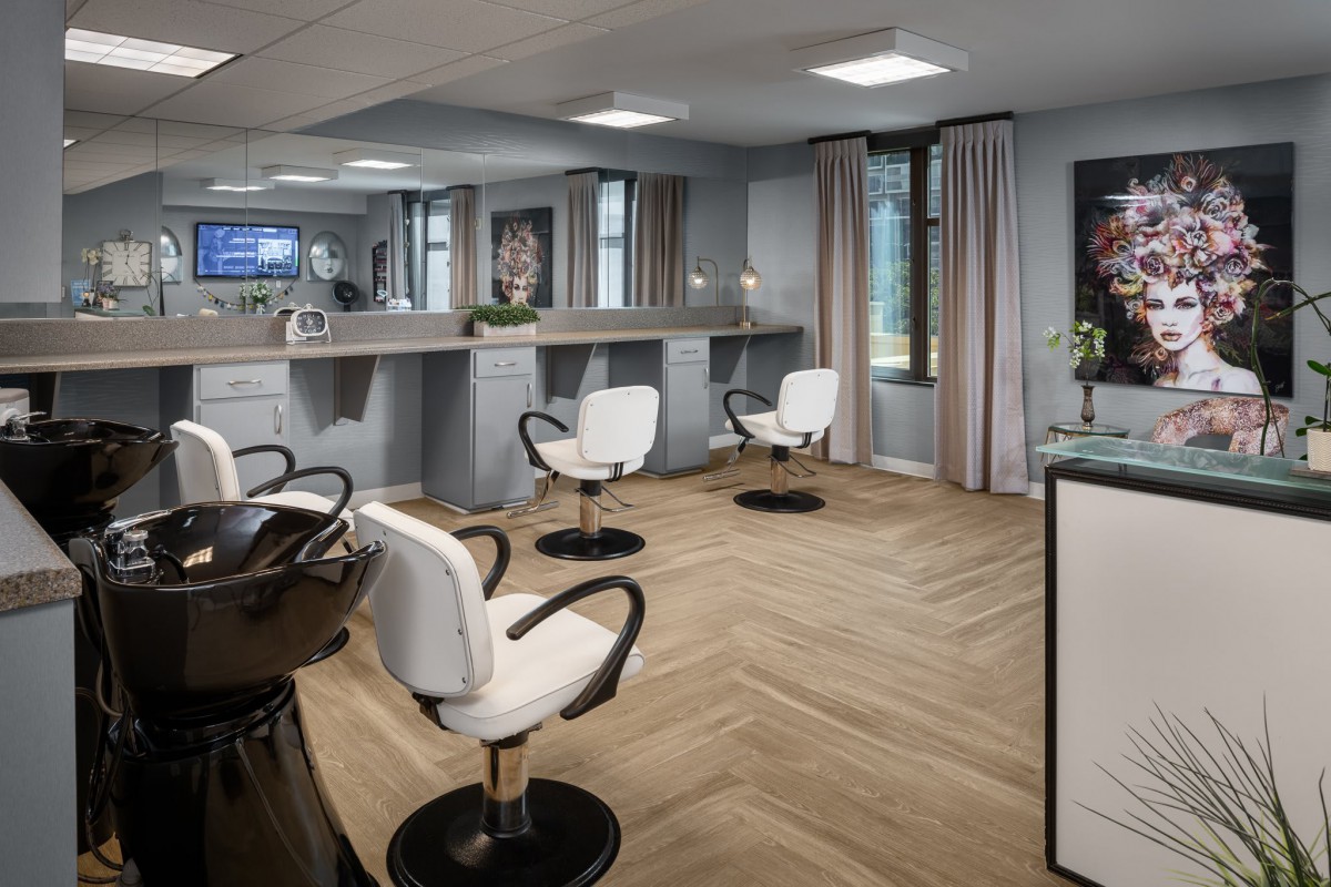 Modern salon interior with stylish chairs and mirrors.