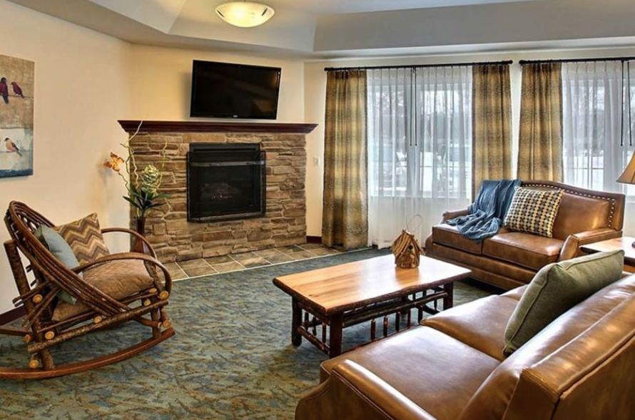 Cozy living room with a stone fireplace and comfortable seating.
