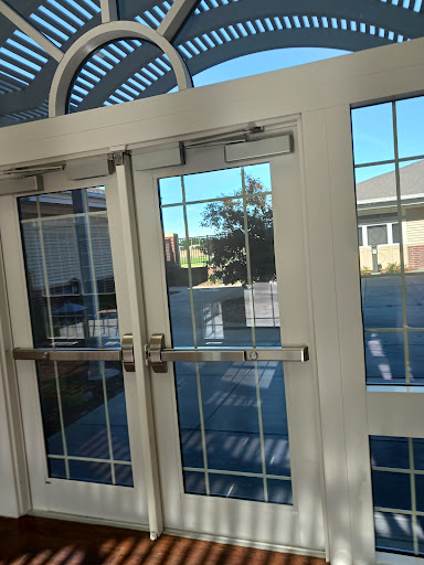 A view of glass doors with a reflection of the outside scenery.