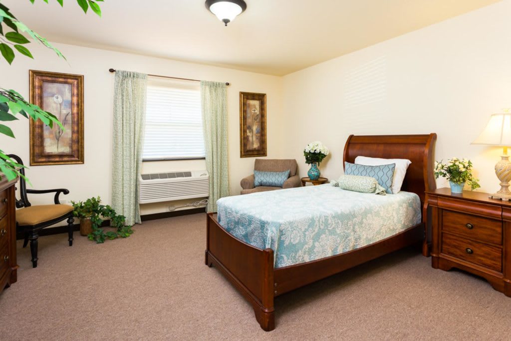 A cozy bedroom with a wooden bed, soft bedding, and tasteful decor.