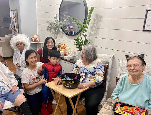 A joyful family gathering, celebrating Halloween with costumes and treats!