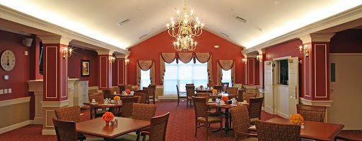 A beautifully designed dining room featuring elegant decor, a chandelier, and comfortable seating arrangements.