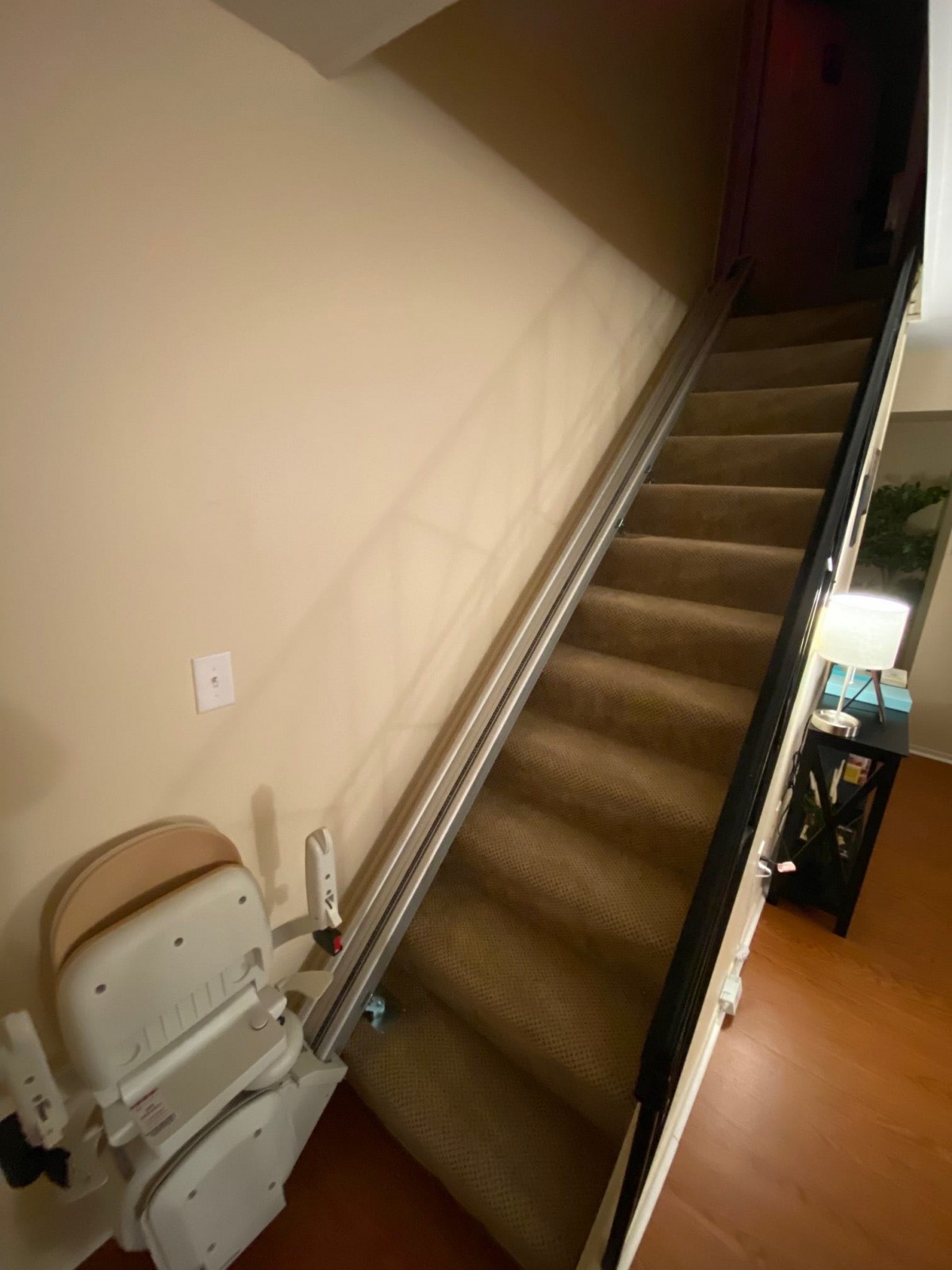 An interior staircase equipped with a chair lift for accessibility.