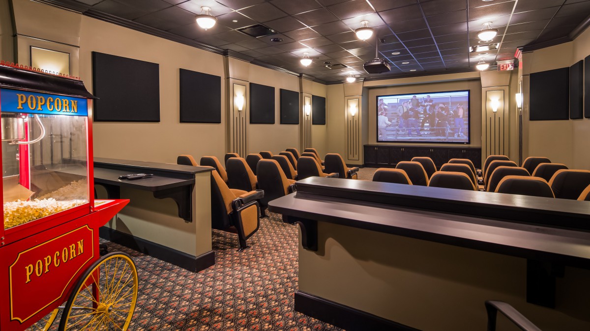 A stylish home theater room with comfortable seating and a large projection screen.