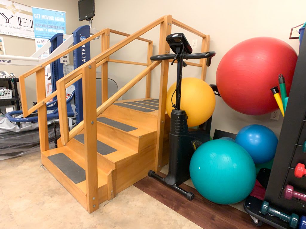 A rehabilitation area featuring therapy stairs and exercise balance balls.