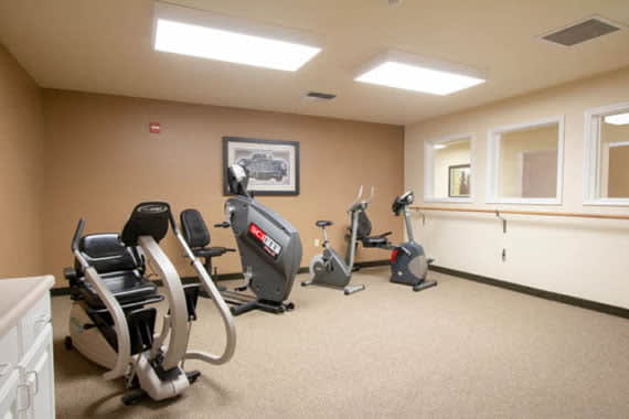 A small gym room with exercise bikes and cardio machines.