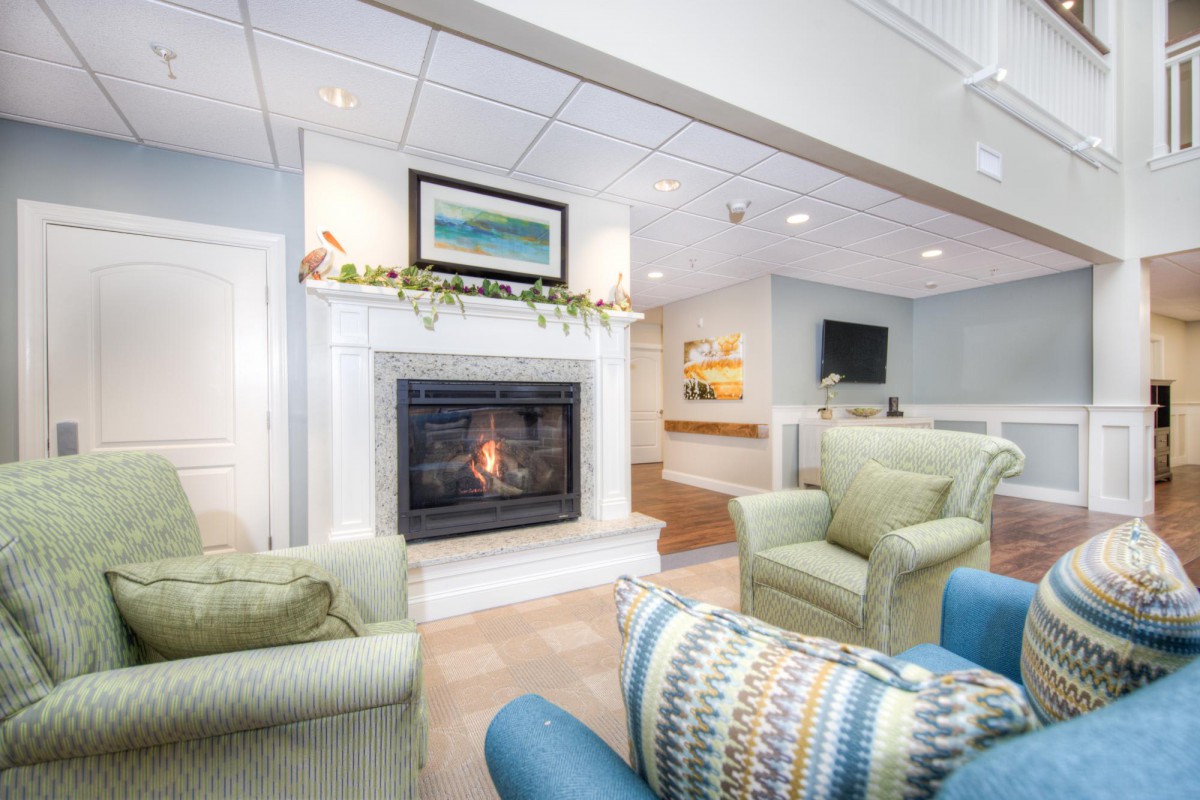 A cozy living room with a fireplace and comfortable seating.