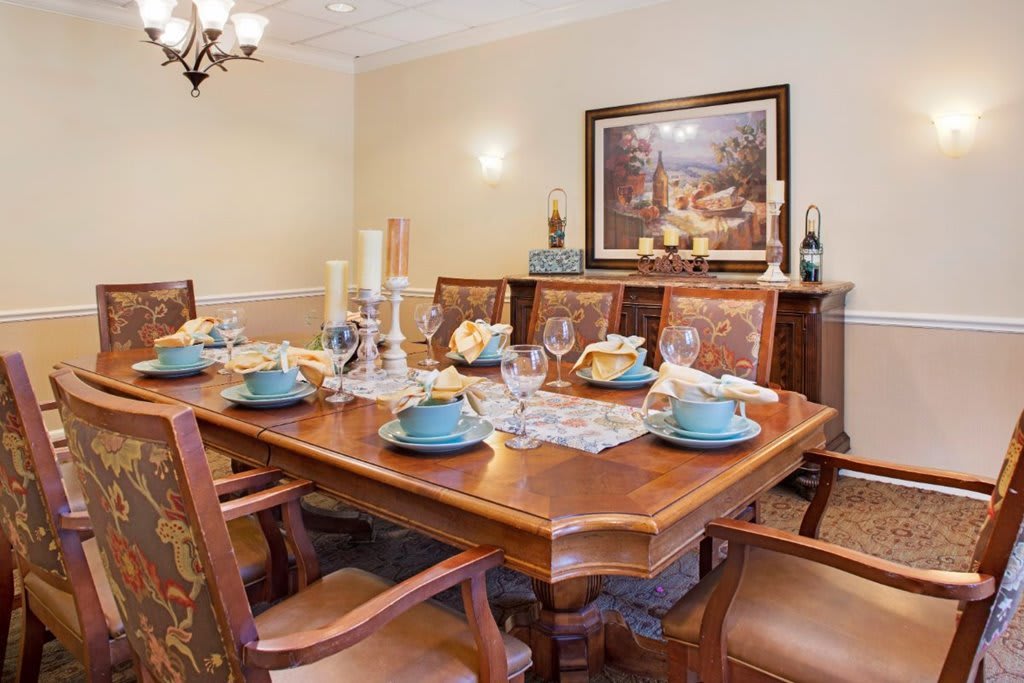 A beautifully set dining room table with elegant decor and artwork.