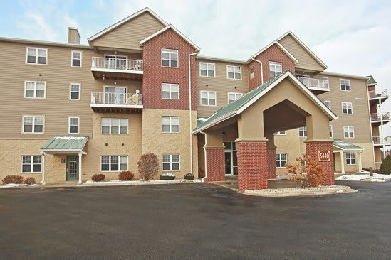 A multi-story residential apartment building with a covered entrance.