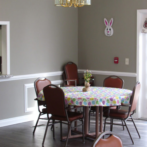 A cozy dining area with a floral tablecloth and comfortable seating, perfect for gatherings.