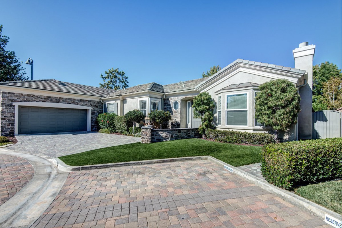 A view of a suburban house with a driveway and attached garage.